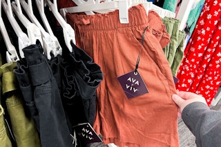 hand grabbing a pair of ava and viv shorts off a target clothing rack