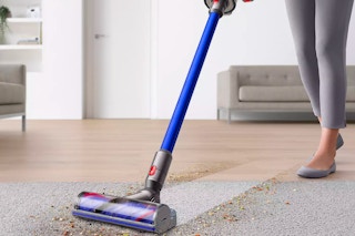 someone vacuuming their carpet with the Dyson V11 Cordless Vacuum