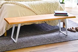 Lifestyle image of the Storied Home Wooden Bench at the end of a bed