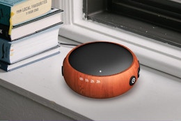 sound machine next to stack of books