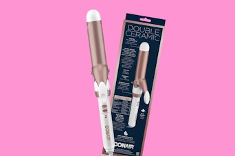 a rose gold and white curling iron next to its packaging 