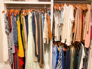 three racks of various clothes side by side and on top of each other in banana republic