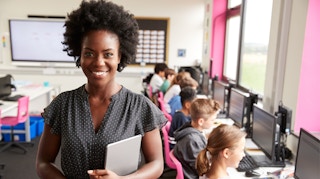 Teacher with students on computers