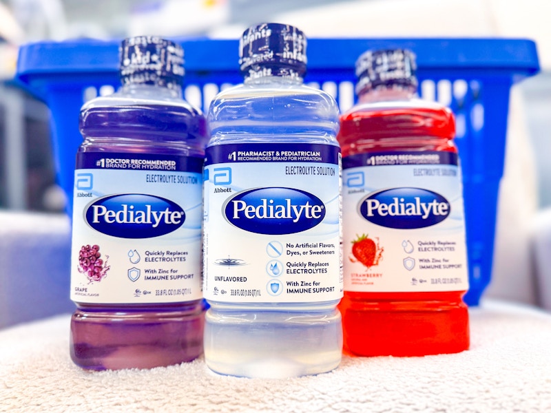 three bottles of pedialyte electrolyte solution in front of walmart hand cart