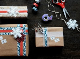 wrapped and decorated gifts next to tape and scissors