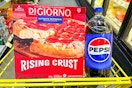 digiorno pizza and a pepsi 2-liter in a yellow shopping cart