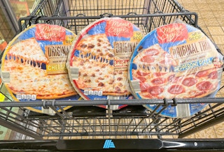 three thin crust pizzas in a cart at aldi