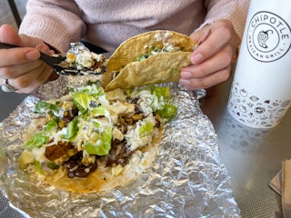 someone filling a taco