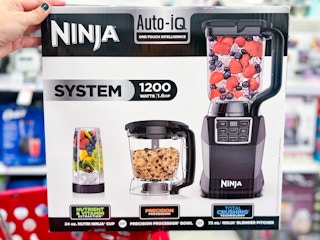 hand holding a ninja kitchen system on a target cart