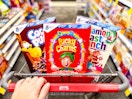 hand pushing a cvs shopping cart with boxes of cereal