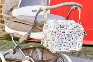 Lifestyle image of Not Before Tea Diaper Bag on baby stroller