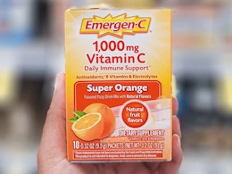 a hand holding a pack of Emergen-C 