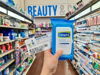 hand holding cetaphil wipes and coupon at walmart