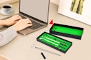 Mini golf pen set on a computer desk.