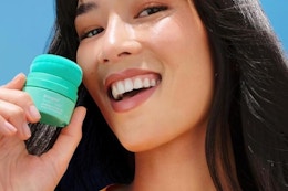 a woman holding briogeo dry shampoo