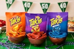 Takis bags and chips on a game day themed table