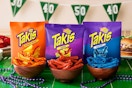 Takis bags and chips on a game day themed table