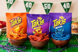 Takis bags and chips on a game day themed table