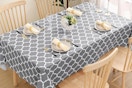 a grey tablecloth on a dining table