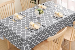 a grey tablecloth on a dining table