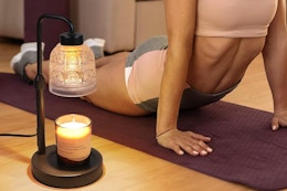 a woman doing yoga near a lamp