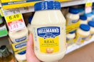 hand holding a jar of hellmans mayo