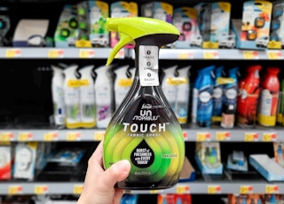 Hand holding Febreze Unstopables Fabric Spray in air freshener aisle at Walmart