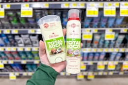 hand holding old spice total body deodorants