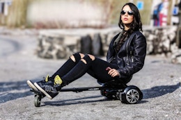 Lifestyle image of a teen using the Hover-1 Buggy Hoverboard Attachment 