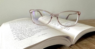 eyeglasses from zenni sitting on an open book