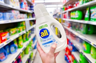 hand holding a bottle of all detergent