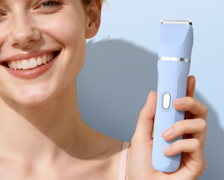 a person holding a blue bikini trimmer
