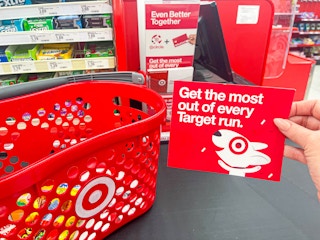 A person’s hand holding up a card that reads “Get the most out of every Target run” with an image of the Target dog printed below it. ...