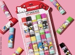 a Hello Kitty lip balm set on a pink background