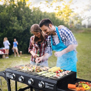people barbecuing outside