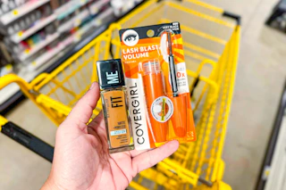 hand holding maybelline and covergirl products