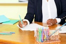 a woman using paper mate pens
