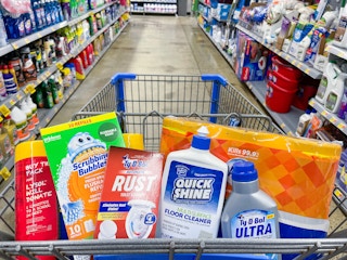 A variety of cleaning supplies lying in a store cart.