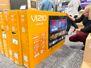 A woman looking at a Vizio tv