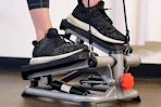 a woman using a mini stepper