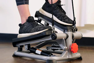 a woman using a mini stepper