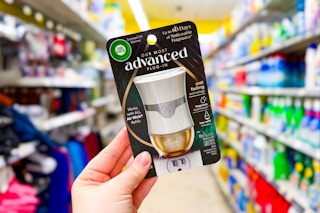 hand holding up an air wick advanced warmer