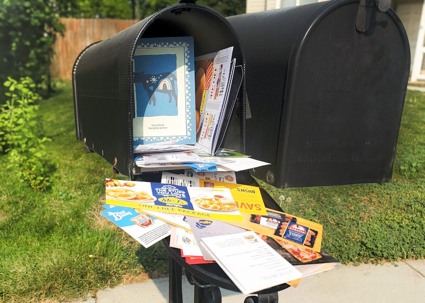 Mailbox overstuffed with coupons