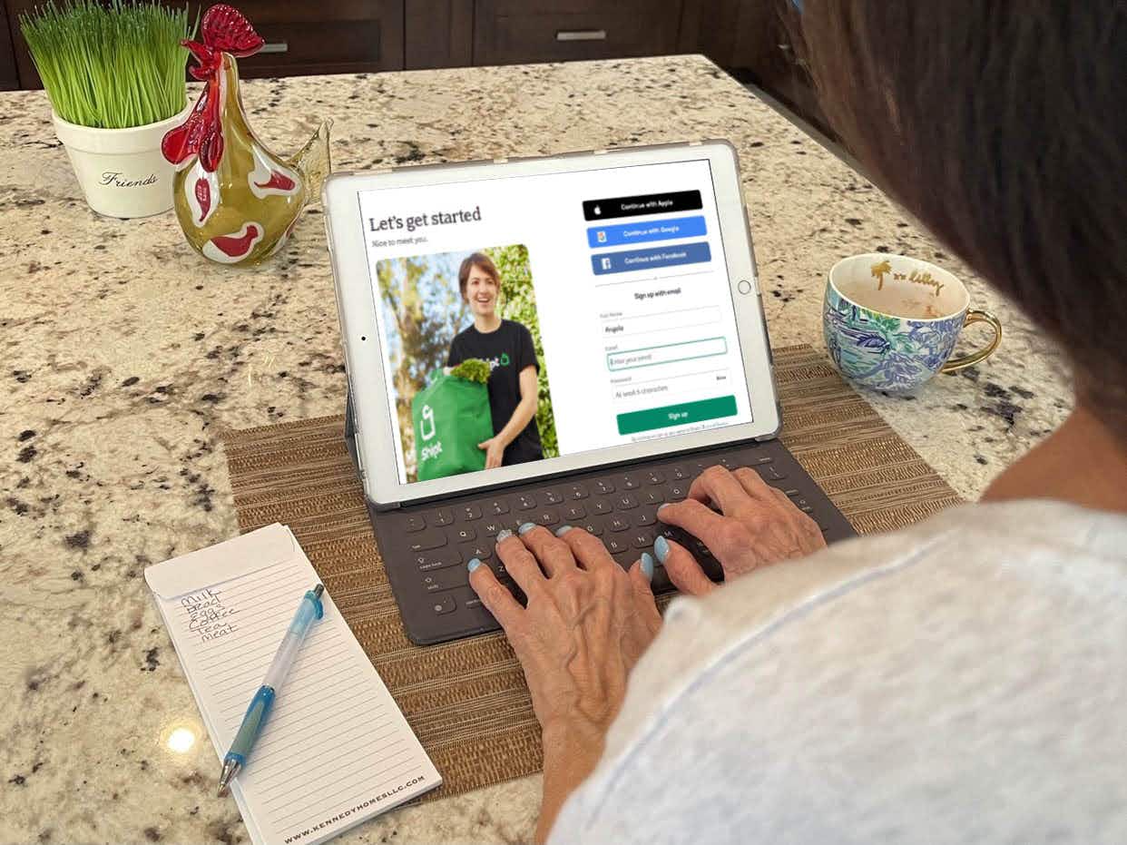 A person using an iPad to sign up for Shipt on their website.