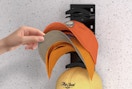 baseball caps on a organizer on the wall 