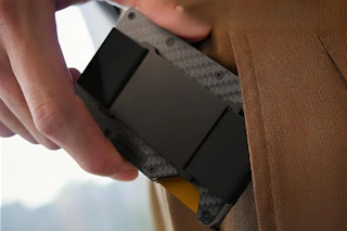 person taking card holder wallet out of wallet