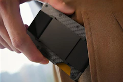 person taking card holder wallet out of wallet