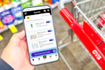 hand holding a smartphone displaying kcl coupons