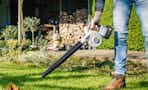 leaf blower being used in yard