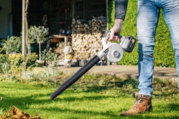 leaf blower being used in yard